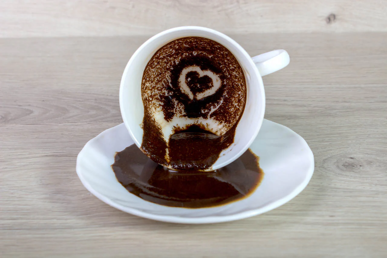 a cup of turkish coffee with a heart on the foam